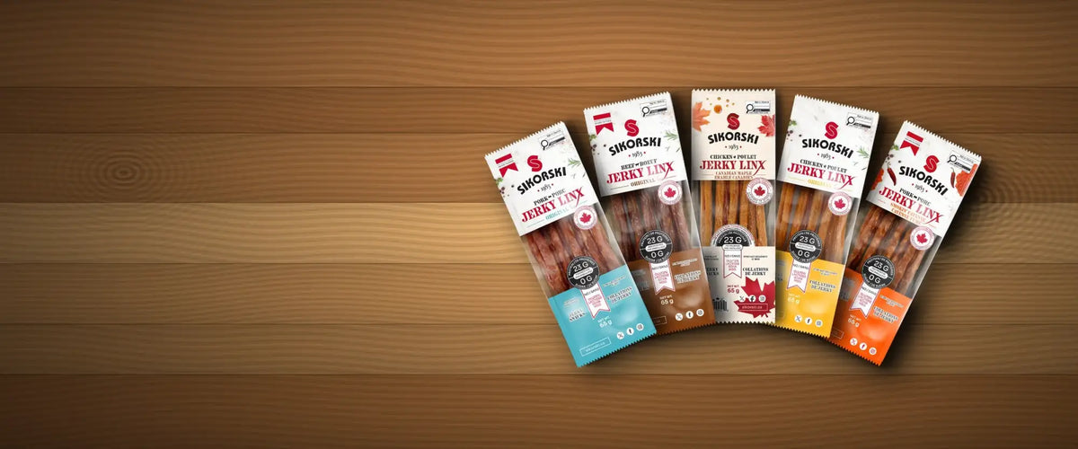 Five individually packaged simorski brand jerky sticks, each in a distinct colored wrapper, blue, brown, white with orange accents, and two shades of orange, with visible product labels and branding.